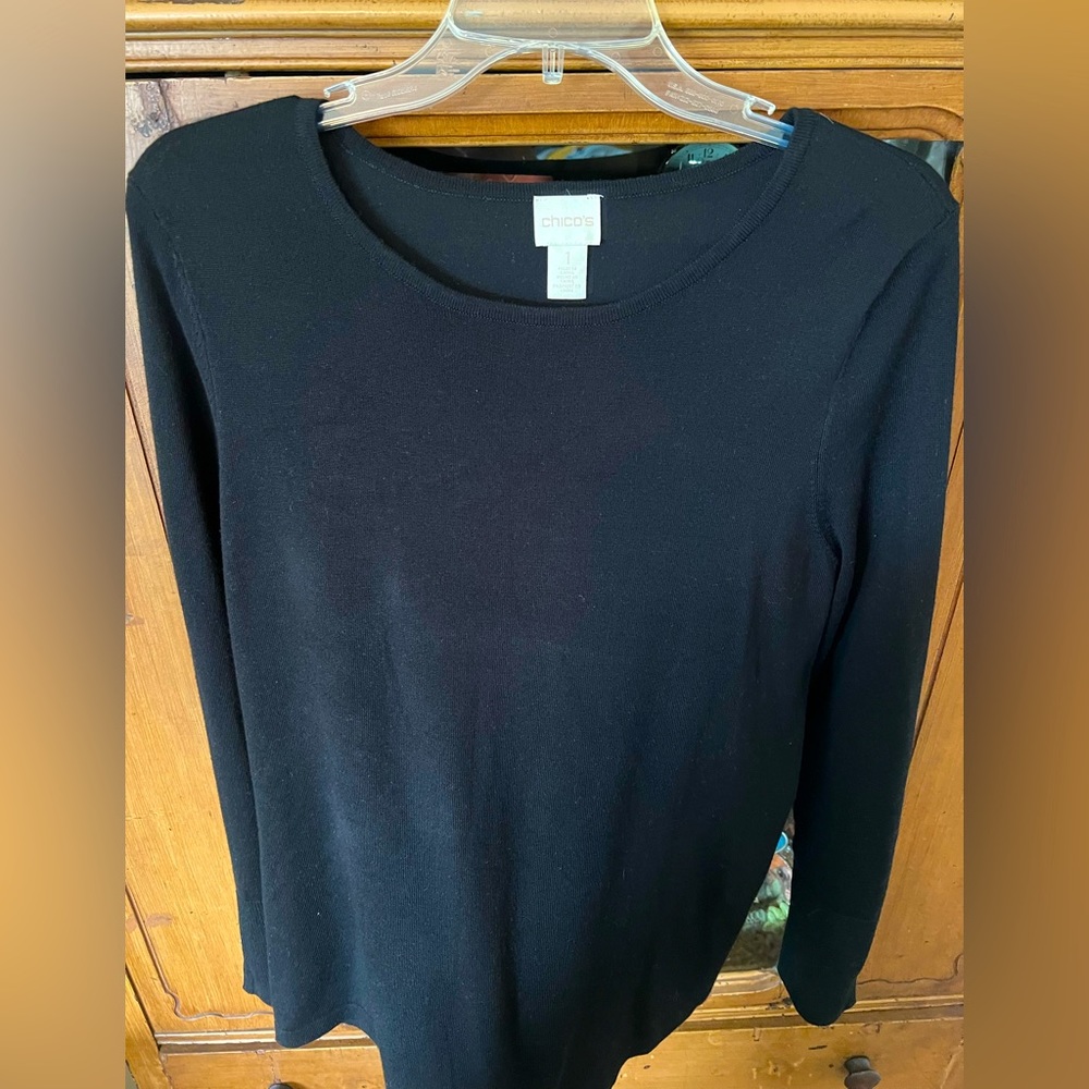 Chico’s long sleeve lightweight black sweater with brass buttons at the sleeve.